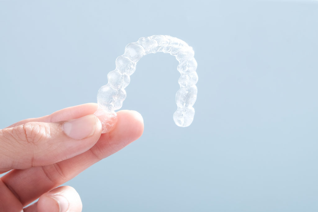 Tampa, FL patient holding their clear aligners